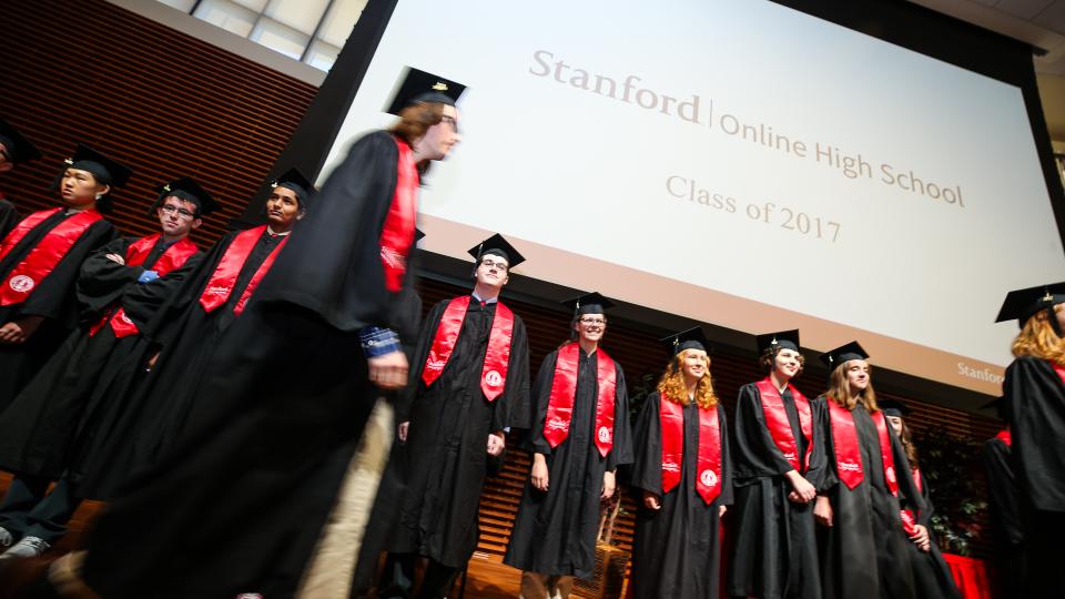 students on stage in robes
